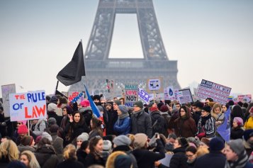 Demonstrators carry placards during a rally in solidarity with supporters of the Women's March in Washington and many other cities on January 21, 2017 at the Place de Trocadero in Paris, one day after the inauguration of the US President Donald Trump. Protest rallies were held in over 30 countries around the world in solidarity with the Washington Women's March in defense of press freedom, women's and human rights following the official inauguration of Donald J Trump as the 45th President of the United States of America. / AFP / ERIC FEFERBERG (Photo credit should read ERIC FEFERBERG/AFP/Getty Images)